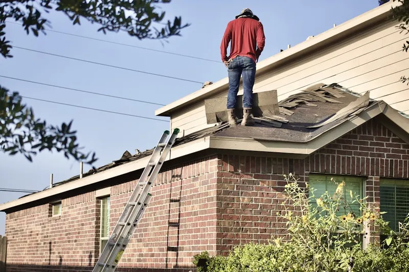 Professional roofer working on a residential roof in Laurelwood